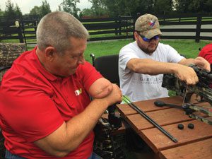 Past National Commander Jim Sursely, who continues to enjoy his passion for archery and hunting despite losing three limbs, works with Marine veteran and double leg amputee Josh Brubaker.