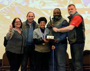 (From left) Caregiver Deborah Shore, VA Secretary Bob McDonald, 2016 DAV Freedom Award Recipient Mariela Meylan, DAV National Commander Moses A. McIntosh Jr. and DAV National Director of Voluntary Services John Kleindienst. Meylan walked up on stage to accept her award using only her cane—a feat she could not have accomplished less than two years ago.