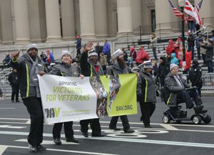 National Commander Dave Riley (seated in scooter) leads DAV’s delegation of representatives down Pennsylvania Avenue during the inaugural parade for President Donald J. Trump. The delegation included (from left) Maryland Past Department Commander Lamarr Couser, National Interim Committee member Jim Procunier, Maryland Chapter 1 Adjutant Chuck Linton, Virginia Chapter 10 1st Junior Vice Commander Layton Lamphere and Riley’s wife, Yvonne.
