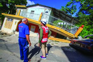 Army veteran looking at damaged house