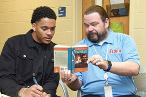 Two men reading book