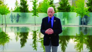 Dale Dye standing at memorial