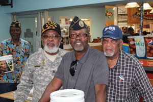 At the Golden Corral Military Appreciation Night in Dallas, Commander A.J. Jones of local DAV Chapter 32 (center) along with J.L. Benson (left) and Robert Benson (right) greet patrons and accept donations.