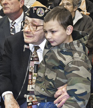 Samuel E. Lanza and his great-great-grandson, Nathaniel Franks, 11, listen Tuesday as various officials honor Lanza’s service to area veterans during his 18 years as the head of the Trumbull County Veterans Service Commission. The new Samuel E. Lanza Veterans Resource Center was named in his honor.