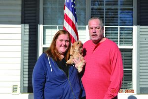 Gary and his wife Sarah standing with dog Gary and his wife Sarah